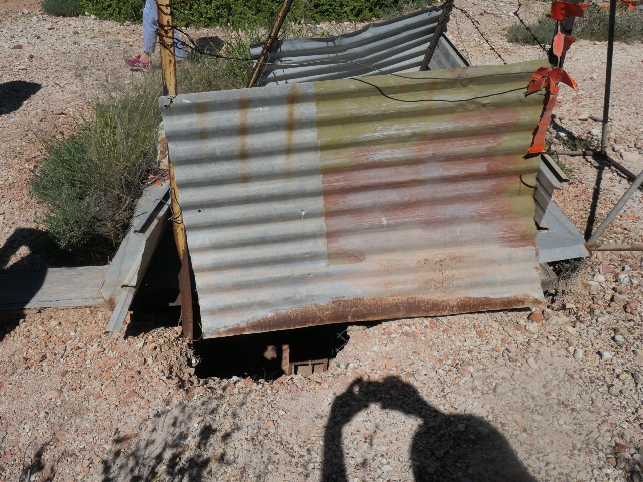 Lightening Ridge Trip - Black Opal tour - The mined areas are littered with abandoned mine shafts. 4 posts and a loop of barbed wire constitute a barrier fence.