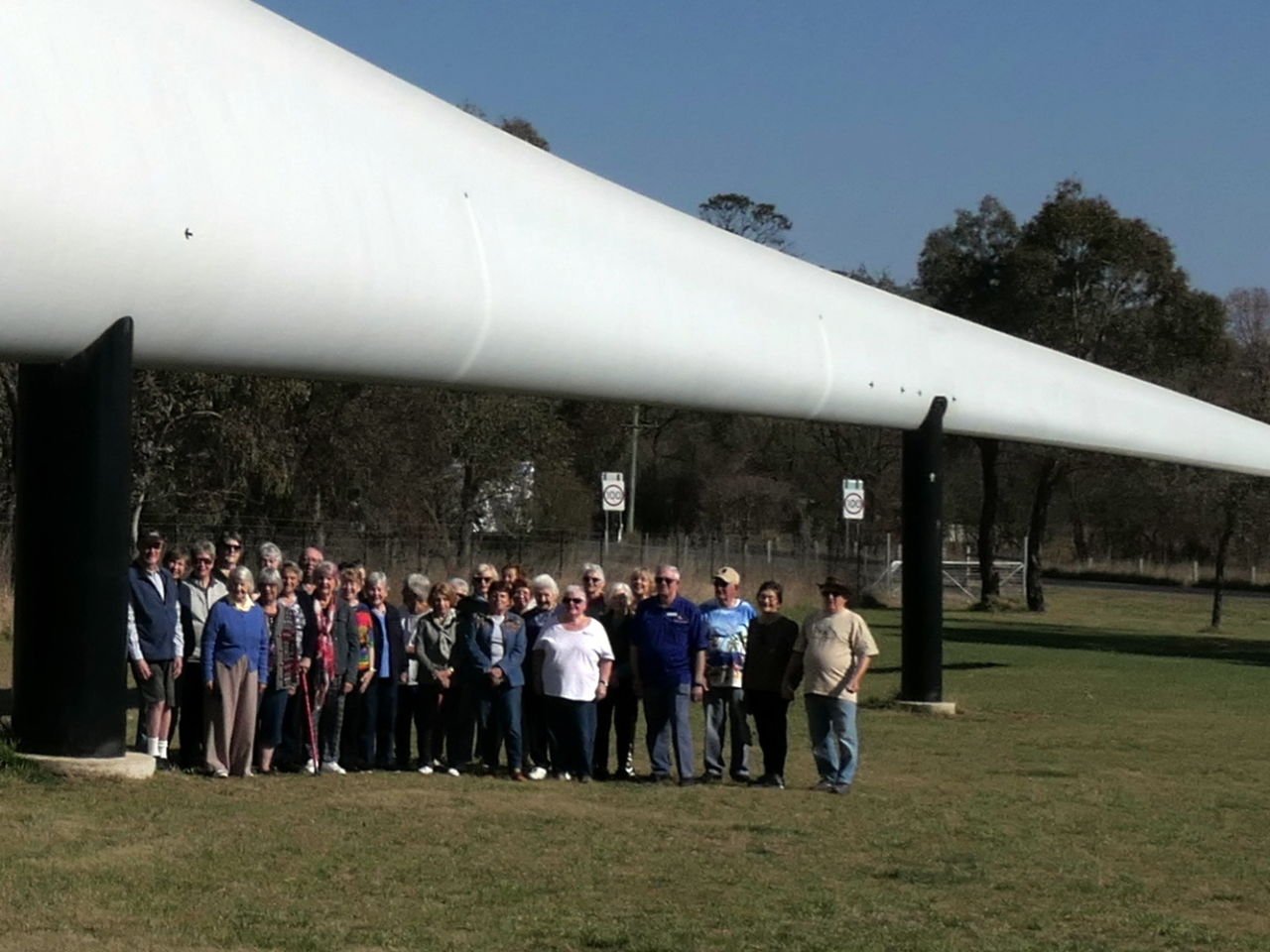 How big is a wind turbine blade - Group photo standing under one blade - Day 7 Dorrigo Trip 2023-09